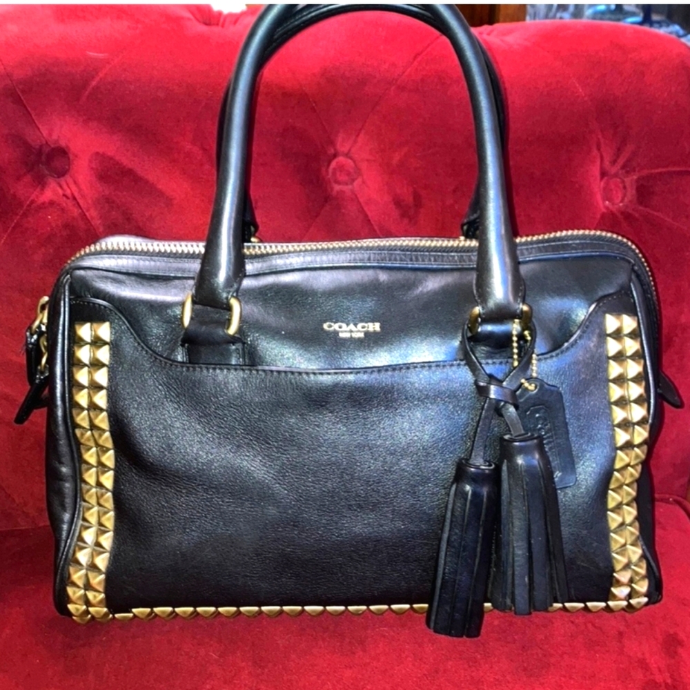 Coach black leather 2 handle gold studded handbag beautiful tassel and tag.